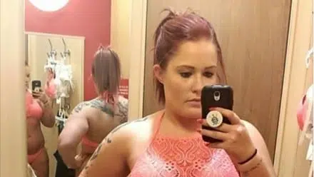 A mother and daughter are trying on swimsuits together and sharing their love yourself message
