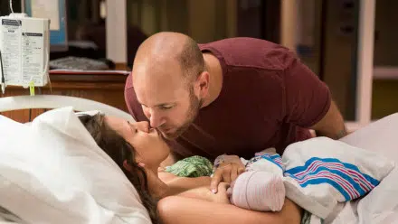 Mother and Father share a kiss in hospital