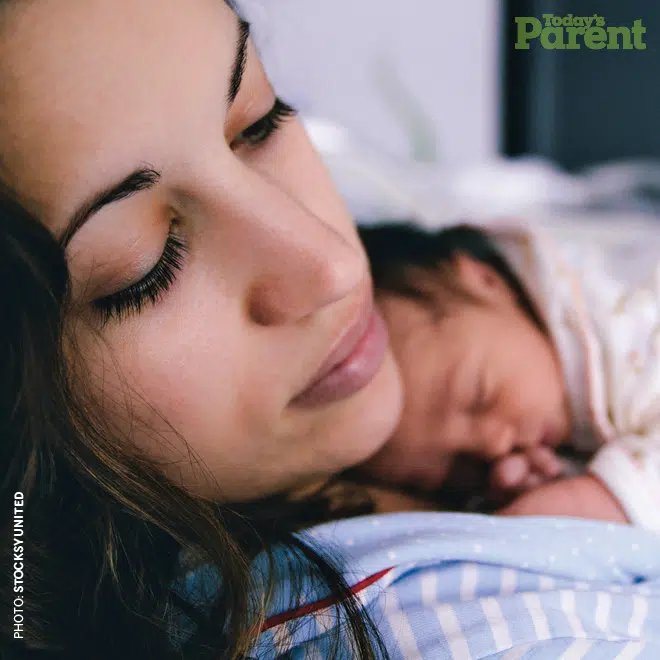 A woman cuddles her baby